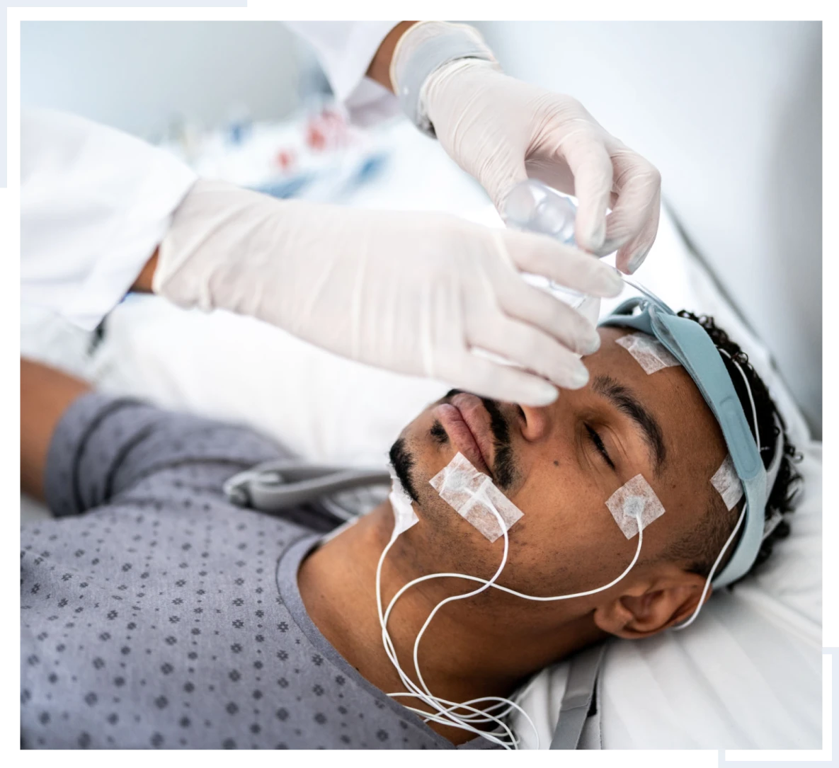 Man undergoing sleep study with electrodes